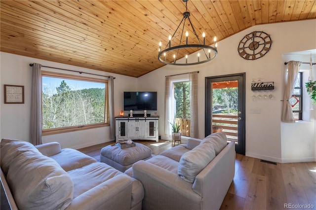 51 Schooley Rd, Bailey, CO 80421 - living room with lofted ceiling, plenty of natural light, a chandelier, wood ceiling, and wood-type flooring