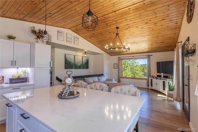 51 Schooley Rd, Bailey, CO 80421 - kitchen with open floor plan, wood ceiling, lofted ceiling, white cabinetry, and wood finished floors