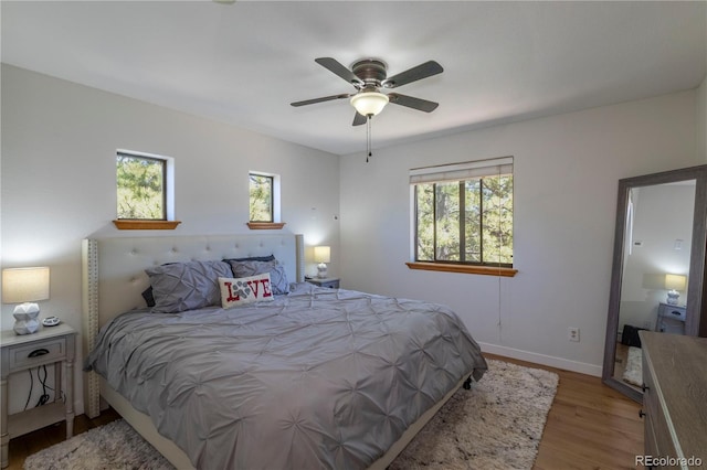 51 Schooley Rd, Bailey, CO 80421 - bedroom with multiple windows, light wood-style flooring, and ceiling fan