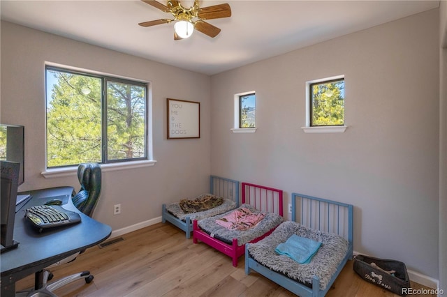 51 Schooley Rd, Bailey, CO 80421 - bedroom featuring wood finished floors, an office area, and a ceiling fan
