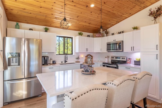 51 Schooley Rd, Bailey, CO 80421 - kitchen with stainless steel appliances, lofted ceiling, wooden ceiling, white cabinets, and tasteful backsplash