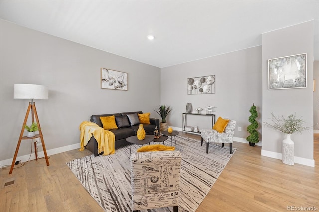 living area with wood finished floors and baseboards