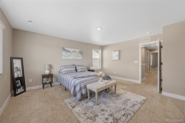 bedroom featuring light colored carpet and baseboards