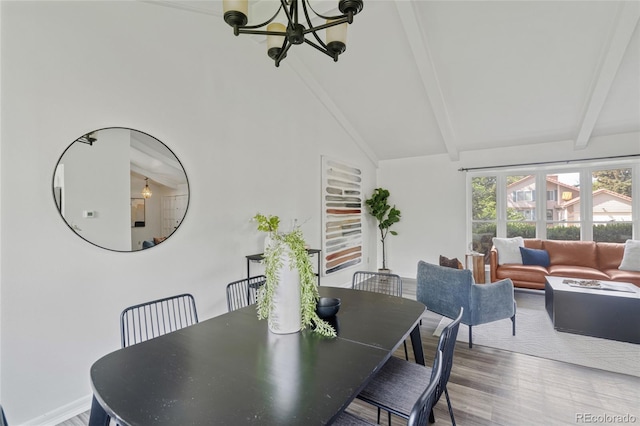 dining space with a chandelier, beam ceiling, wood finished floors, high vaulted ceiling, and baseboards