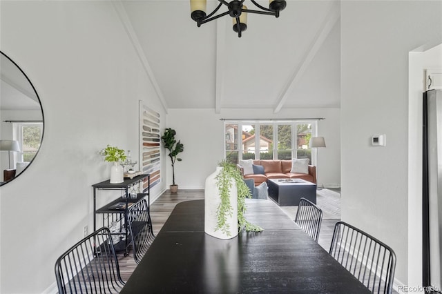 dining room with beamed ceiling, baseboards, wood finished floors, and high vaulted ceiling