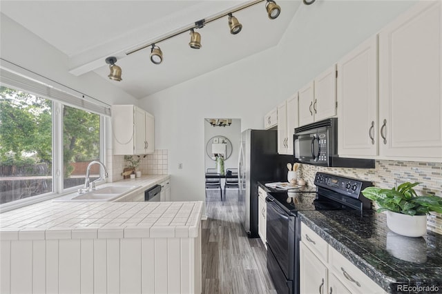 kitchen with black appliances, a sink, white cabinetry, tasteful backsplash, and wood finished floors