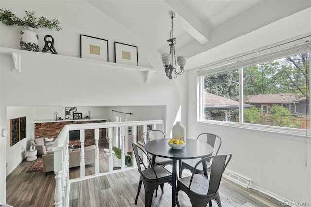 dining area featuring a chandelier, wood finished floors, and baseboards