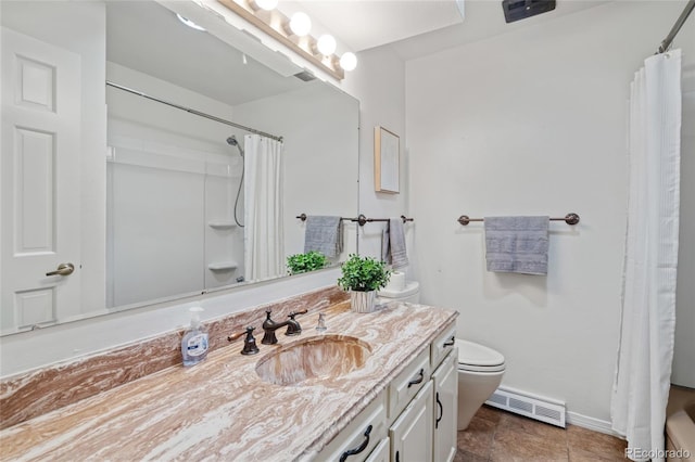 bathroom featuring toilet, baseboards, and vanity