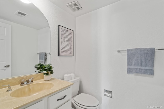 half bathroom with vanity and toilet