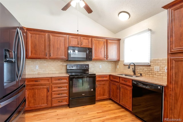 7732 Xavier Ct, Westminster, CO 80030 - kitchen with black appliances, a sink, lofted ceiling, light stone counters, and a ceiling fan