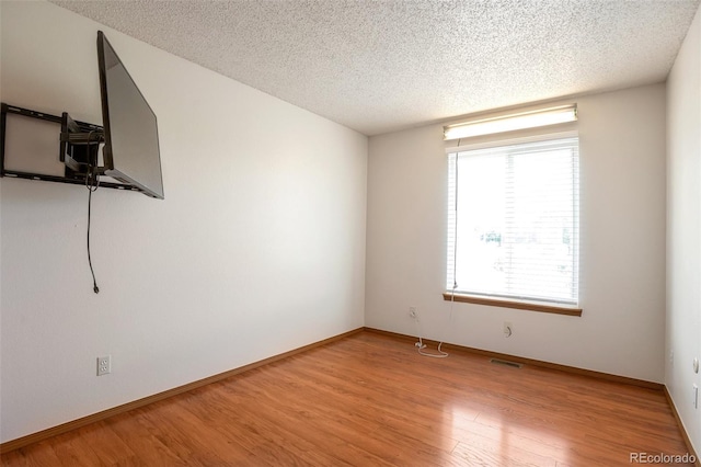 7732 Xavier Ct, Westminster, CO 80030 - empty room with a textured ceiling, light wood finished floors, and baseboards