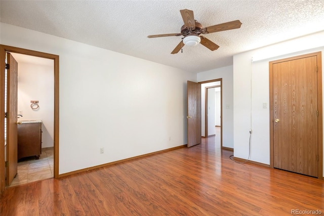 7732 Xavier Ct, Westminster, CO 80030 - unfurnished bedroom featuring wood finished floors, a textured ceiling, baseboards, and ceiling fan