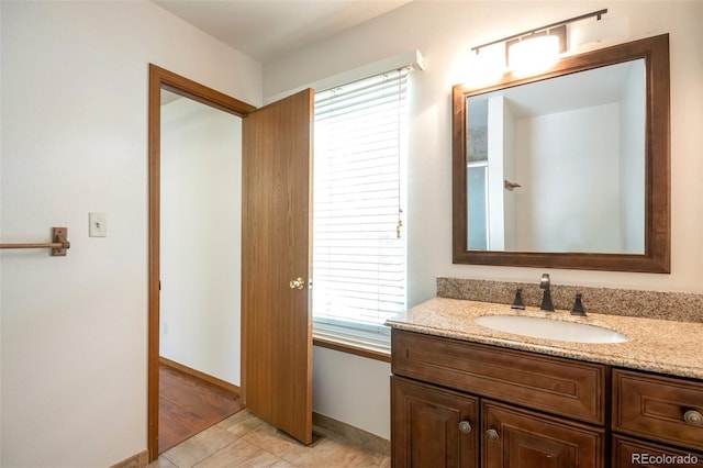 7732 Xavier Ct, Westminster, CO 80030 - bathroom featuring vanity, baseboards, and tile patterned flooring