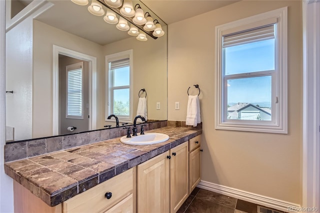 bathroom with baseboards and vanity