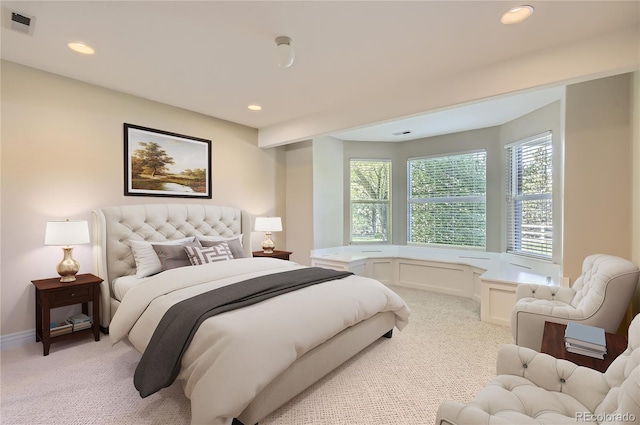 bedroom with light carpet and recessed lighting
