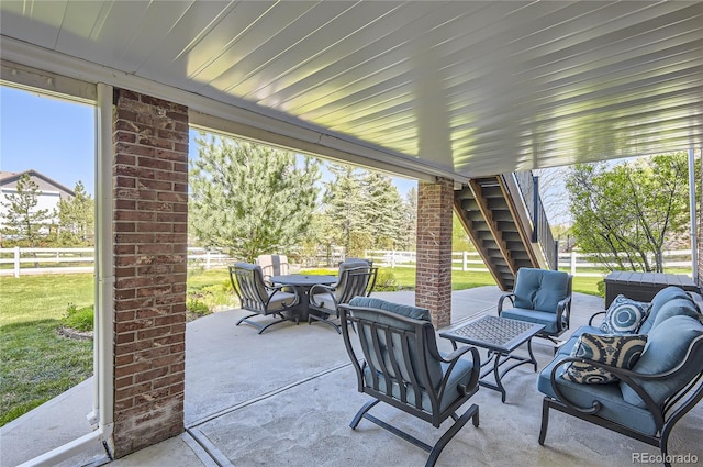 view of patio / terrace featuring outdoor lounge area, outdoor dining space, and stairway