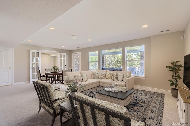 carpeted living area featuring baseboards, recessed lighting, and french doors