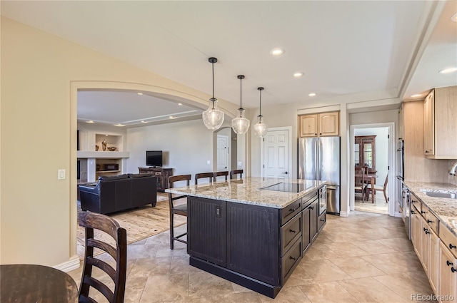 10529 Dacre Pl, Lone Tree, CO 80124 - kitchen featuring stainless steel appliances, a breakfast bar, light brown cabinets, arched walkways, and recessed lighting