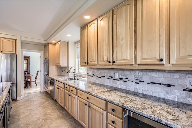 10529 Dacre Pl, Lone Tree, CO 80124 - kitchen featuring stainless steel appliances, light brown cabinets, light stone counters, decorative backsplash, and recessed lighting
