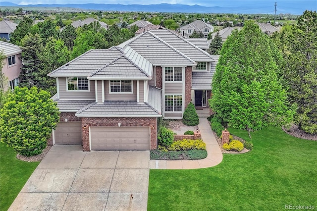 10529 Dacre Pl, Lone Tree, CO 80124 - traditional-style home with brick siding, a garage, concrete driveway, a front lawn, and a mountain view