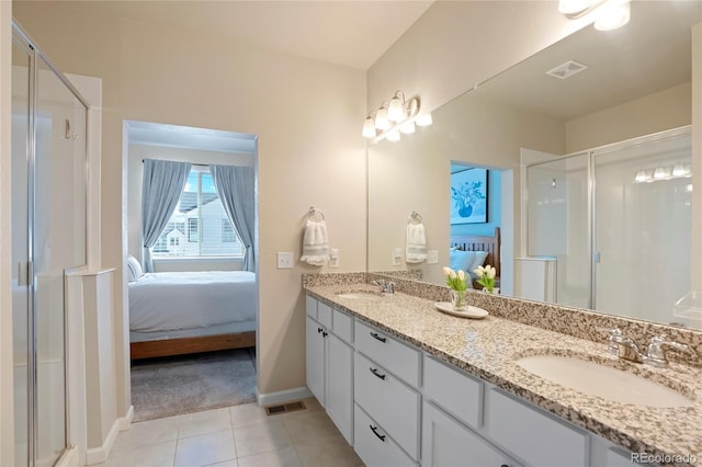 ensuite bathroom featuring ensuite bathroom, visible vents, and a sink