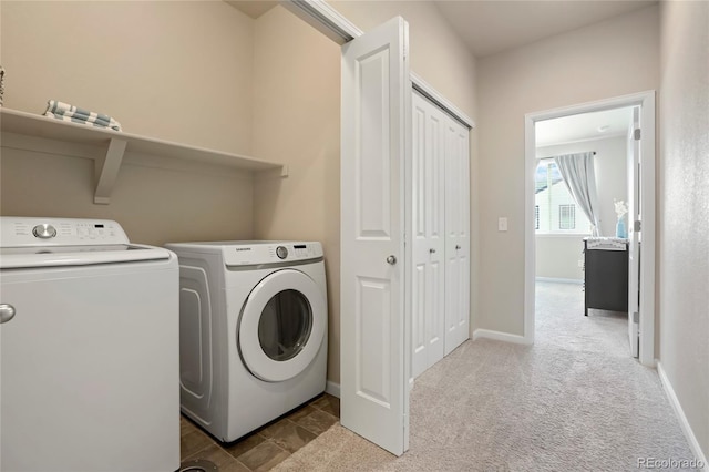 laundry area featuring washer and clothes dryer, laundry area, carpet flooring, and baseboards