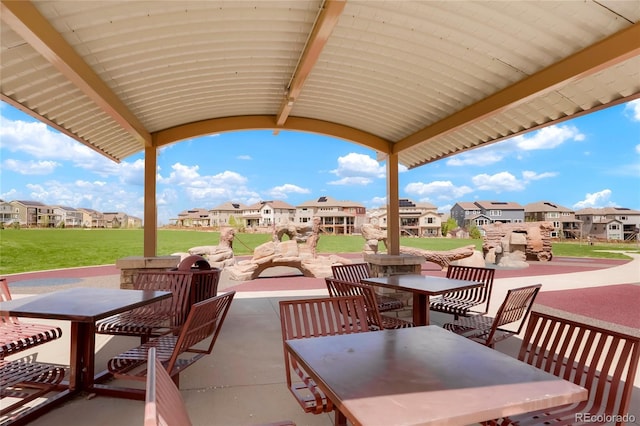 view of patio featuring outdoor dining space and a residential view