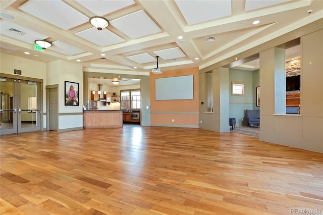 unfurnished living room with coffered ceiling, light wood-style floors, visible vents, and recessed lighting