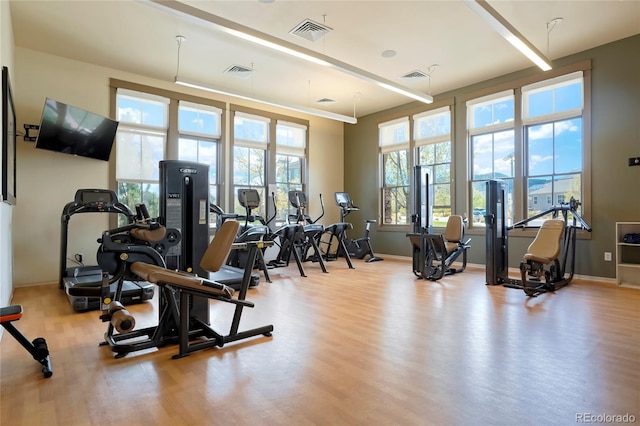 workout area with visible vents and wood finished floors