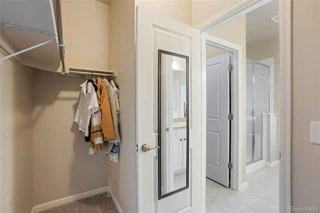 walk in closet featuring light tile patterned floors