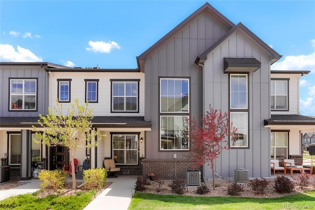 multi unit property featuring cooling unit and board and batten siding