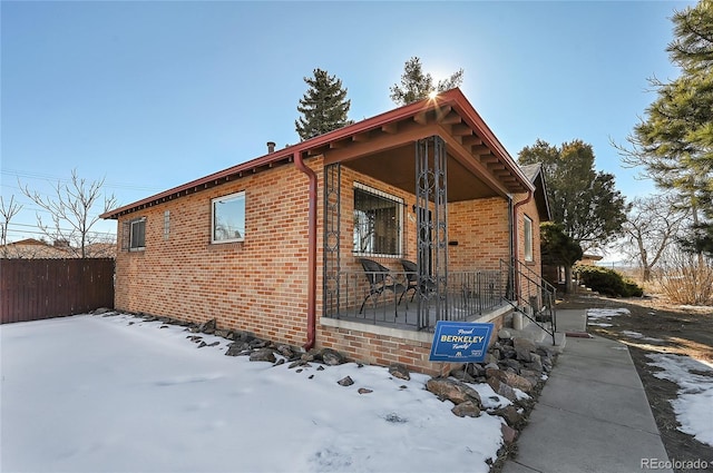 view of snow covered exterior featuring a porch