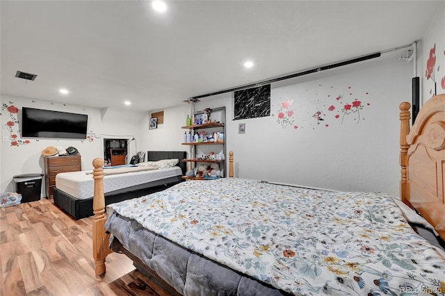 bedroom with hardwood / wood-style flooring