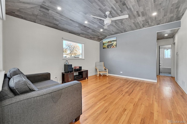 living room featuring hardwood / wood-style flooring, lofted ceiling, a healthy amount of sunlight, and ceiling fan