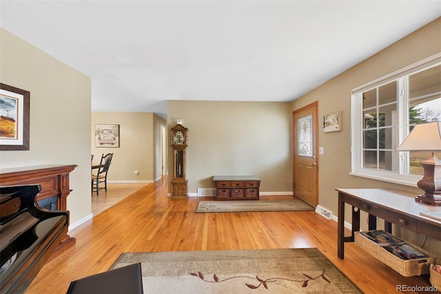 entryway with visible vents, baseboards, and wood finished floors