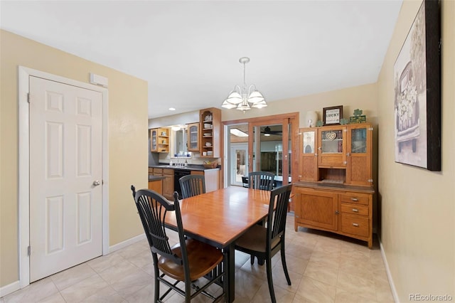 dining room with baseboards, a notable chandelier, and light tile patterned flooring