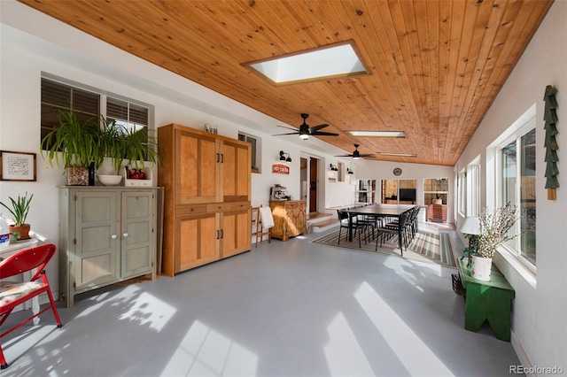 interior space with vaulted ceiling with skylight and wooden ceiling