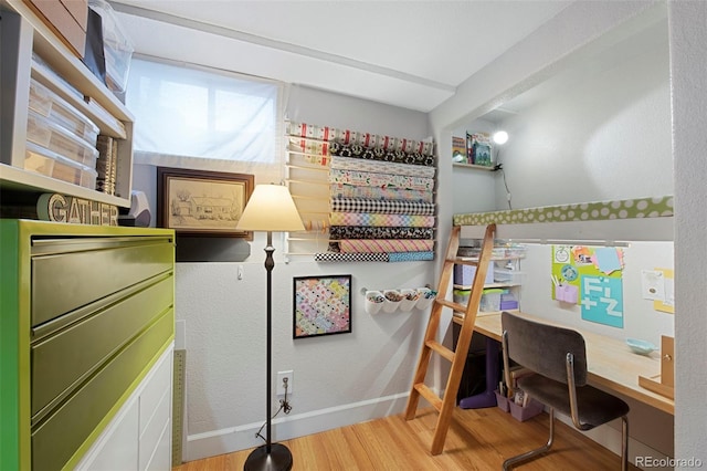 bedroom with baseboards and wood finished floors