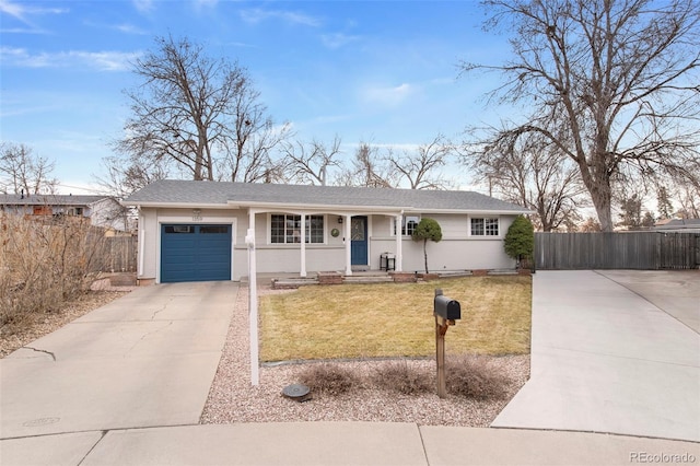 single story home with a garage, concrete driveway, a front yard, and fence