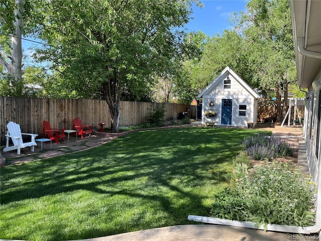 1359 Chambers Rd, Aurora, CO 80011 - view of yard featuring an outdoor structure and a patio