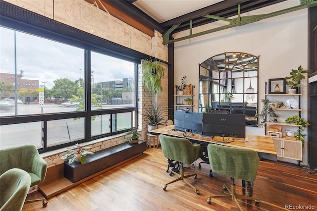 1203 24th St, Denver, CO 80205 - office featuring beam ceiling, wood finished floors, and a towering ceiling