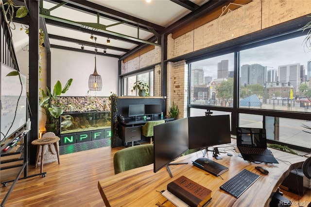 1203 24th St, Denver, CO 80205 - office space featuring wood finished floors, beamed ceiling, healthy amount of natural light, and a high ceiling
