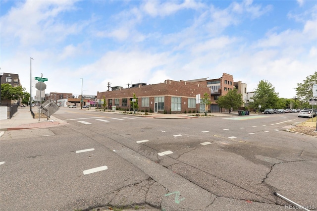 1203 24th St, Denver, CO 80205 - view of asphalt street with sidewalks, curbs, and traffic signs