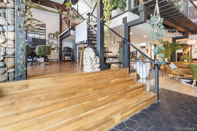 1203 24th St, Denver, CO 80205 - staircase featuring a high ceiling, recessed lighting, and wood finished floors