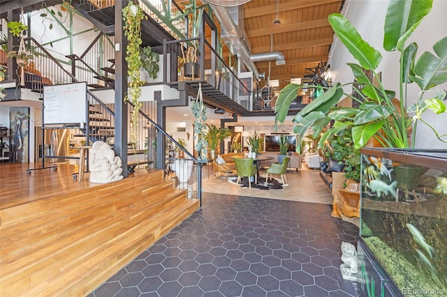 1203 24th St, Denver, CO 80205 - building lobby with stairs, a towering ceiling, and wooden ceiling with exposed beams