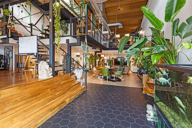 1203 24th St, Denver, CO 80205 - building lobby featuring stairway, a towering ceiling, and a wooden ceiling with exposed beams