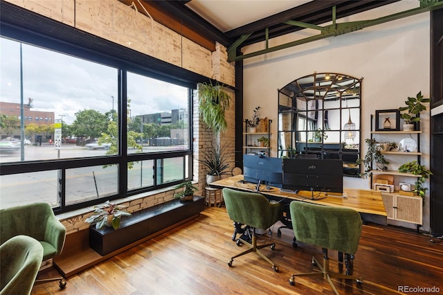 1203 24th St, Denver, CO 80205 - home office featuring wood finished floors, beam ceiling, and a high ceiling