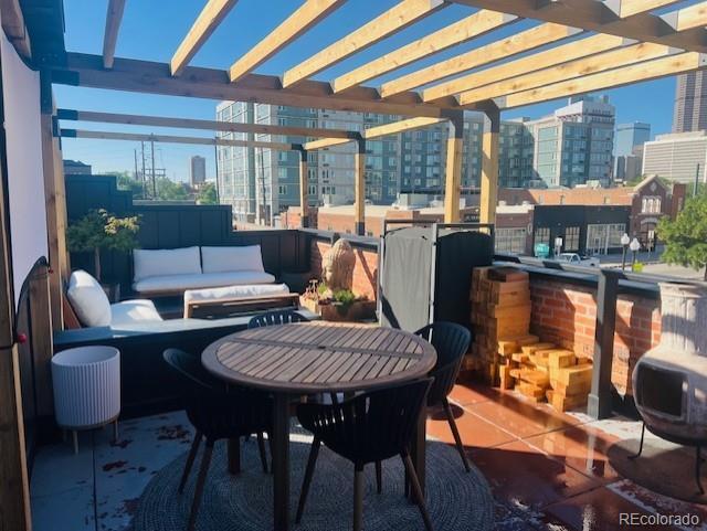 1203 24th St, Denver, CO 80205 - view of patio / terrace featuring a view of city, a pergola, and an outdoor hangout area