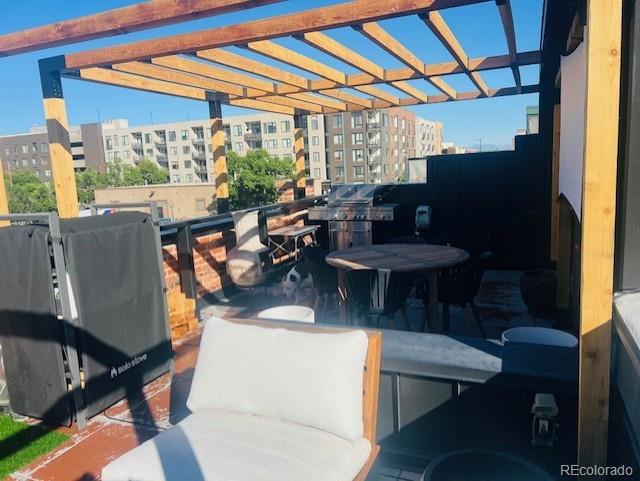 1203 24th St, Denver, CO 80205 - view of patio / terrace with a city view and a grill