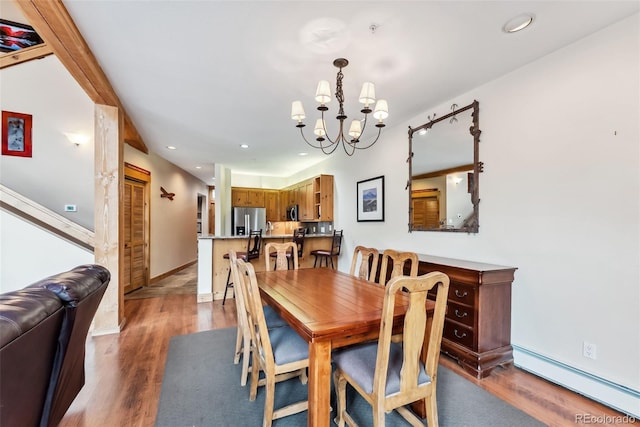 dining room with baseboard heating, a chandelier, wood finished floors, recessed lighting, and baseboards